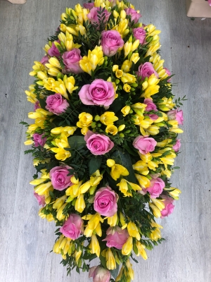 Yellow freesia and pink roses coffin spray