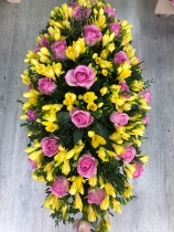 Yellow freesia and pink roses coffin spray
